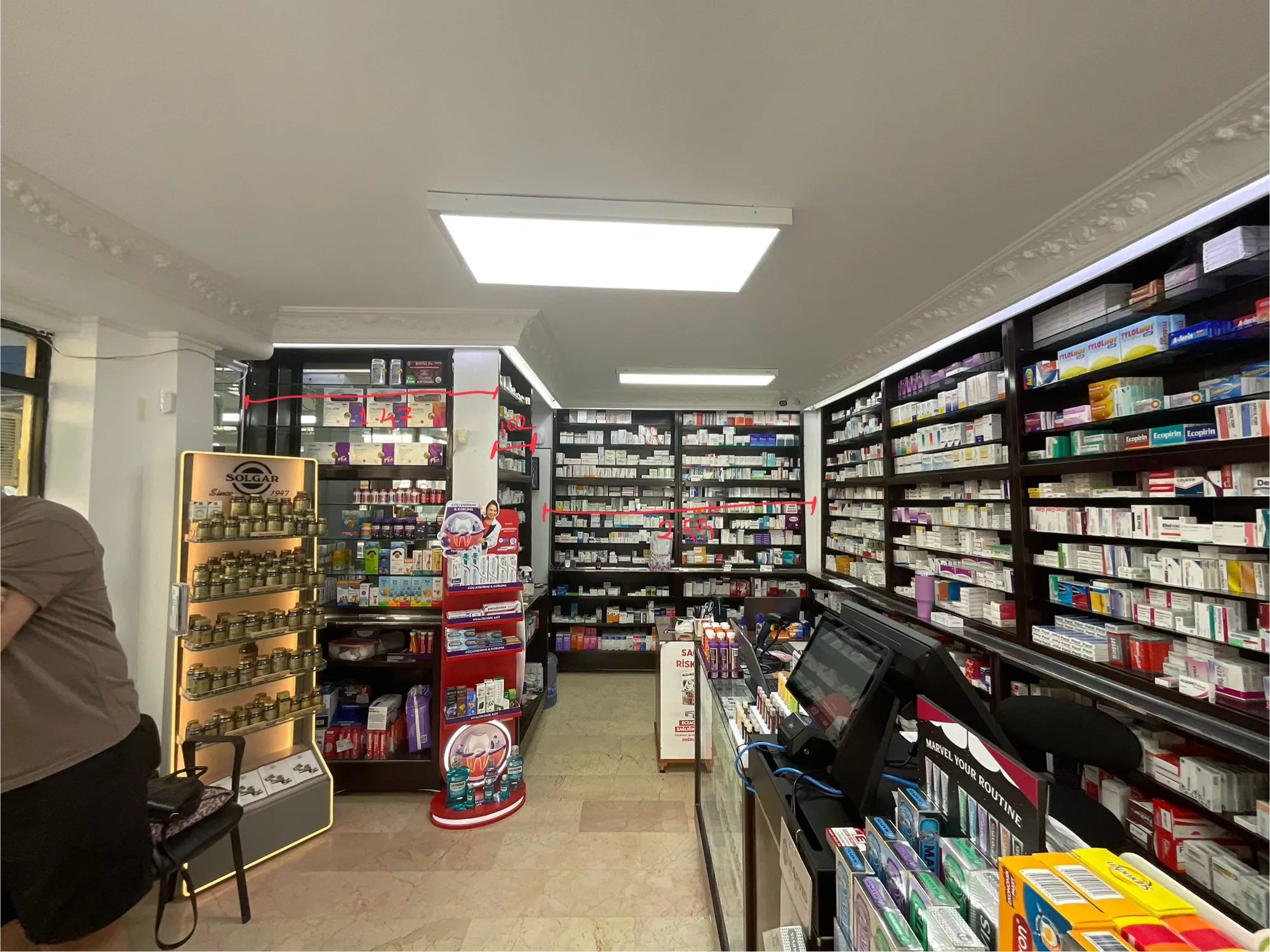 Existing condition before renovation: the aisle between full shelves and free-standing display stands