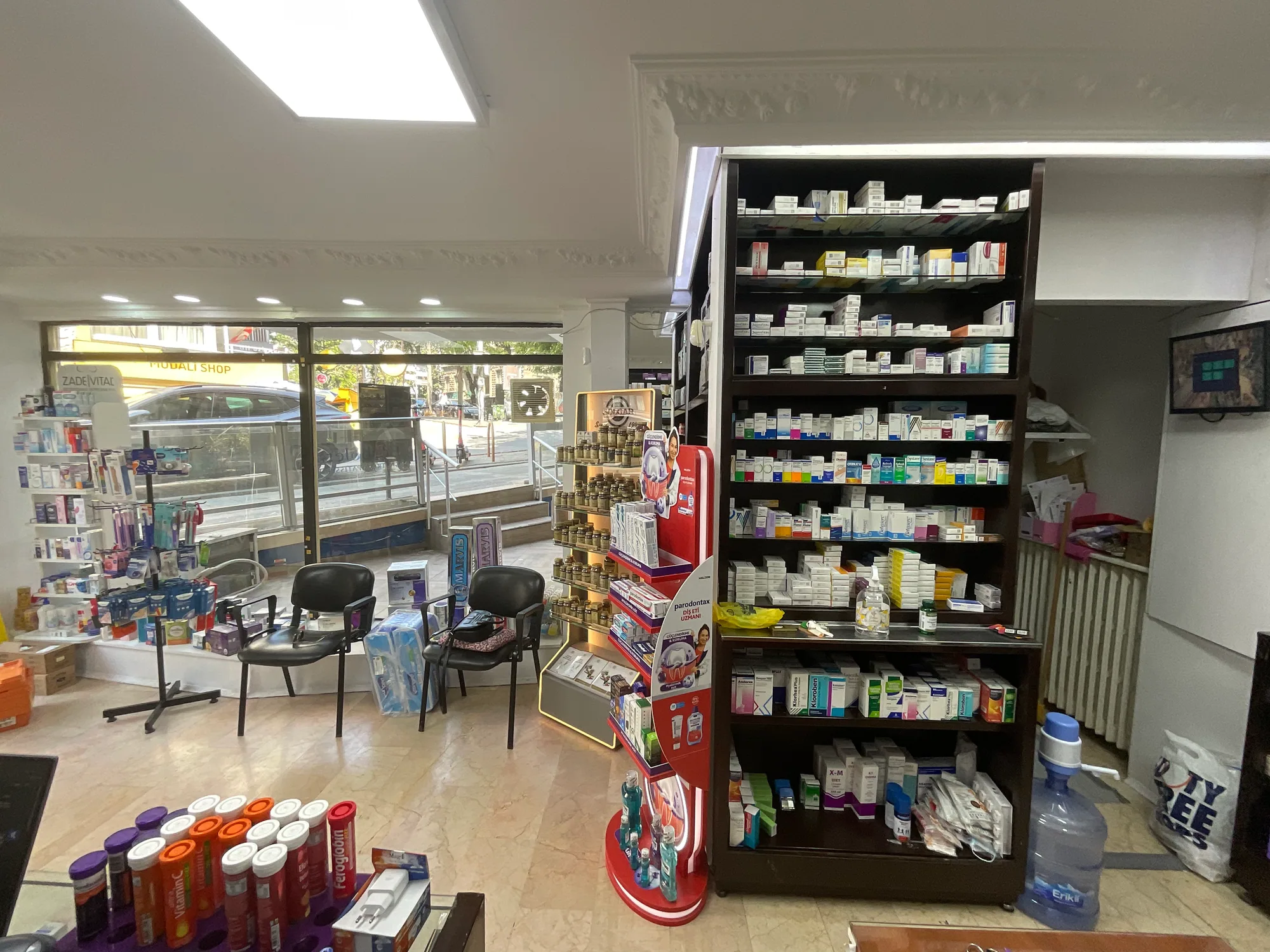 Existing condition before renovation: waiting chairs at the street frontage and shelving to ceiling height